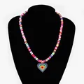 Detailed macro view of vibrant rainbow heart pendant on colorful heishi beaded necklace - Large Heart Necklace / Blue