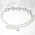 Macro shot of silver crescent moon and star charms on a stylish metal waist chain belt - Moon Waist Chain / Silver