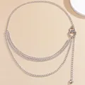 Macro view of silver triple-layered metal body chain featuring heart buckle and pendant - Silver Heart Waist Chain
