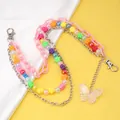 Macro detail of layered pink acrylic chains and a colorful flower bead body chain - Large Butterfly Pendant Multi-layer Pants Chain
