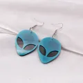 Neon green acrylic alien drop earrings on white satin fabric for a trendy street style - Blue