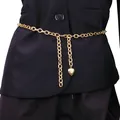 Gold layered body chain featuring a cross link design and textured heart pendant on black suit - Gold Heart Pendant Waist Chain / Gold