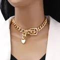 Chunky gold chain choker featuring a belt buckle clasp and heart pendant on a model - Gold Buckle Necklace