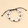 Close-up of handmade shell necklace with adjustable black wax cord and seven cowries - Black Rope Shell Bracelet