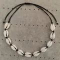 Detail of natural white cowrie shell necklace with adjustable black cord and silver beads - Black Rope Shell Necklace