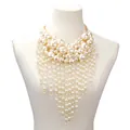 Statement multilayer pearl tassel bib necklace with gold hardware on a mannequin - Gold
