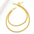 Close-up of golden double-layer punk pants chain with a hollow cross pendant and clasps - Layered Chain Cross Style / Gold