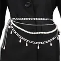 Layered pearl body chain with silver Cuban links and drop pendants over a black suit - Silver