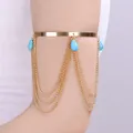 Bohemian gold arm cuff featuring layered tassel chains and turquoise teardrop beads - Turquoise Tassel Style / Gold