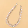 Detail of double-layer bag strap with silver metal chain and white faux pearls - Pearl Style