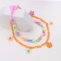 Detail of colorful acrylic chain with smiley flower pendants and pink plastic hook - Flower Style
