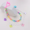Macro detail of candy-colored acrylic heart flower pendants on double-layered chain - Heart Style