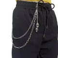 Detailed view of silver punk waist chain with triple layers and skull charms on black pants - Skull Layered Chain / Silver