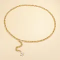 Detailed shot of gold metal waist chain featuring sparkling four-leaf flower pendant - Gold Flower Pendant