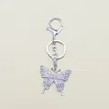 Macro detail of silver butterfly keychain with sparkling crystal rhinestones inlay - Silver