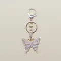 Close-up of alloy butterfly keychain with sparkling white zircons and lobster clasp detail - Gold
