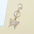 Close-up of colorful rhinestone butterfly keychain with golden lobster clasp and ring - Colorful