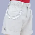 Detail of white denim shorts featuring layered neon acrylic and silver bead chains - White