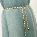 Detail view of a gold chain waist belt with oval links and round ball charms on a sweater - Style 3 Waist Chain - Gold