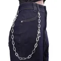 Detail of silver star pendant on thick metal chain draped over blue denim jeans - Silver