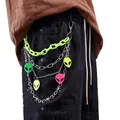 Detail of neon green plastic chain and metal thorn chains with colorful alien charms - Green