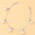 Close-up of sparkling rhinestone shoe chain with five elegant pearl pendants and clasps - Silver