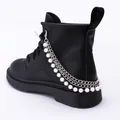 Detail of multi-layer pearl and silver chain charms on a black matte leather boot - Pearl And Chain