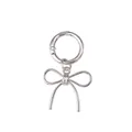 Close-up of a silver bow-shaped metal shoe pendant with a round spring buckle clip - Bow