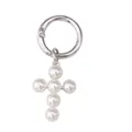 Macro detail of gothic pearl cross charm with silver metal spring ring clasp accessory - Pearl Cross