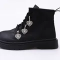 Silver hollow heart butterfly charms with lobster clasps attached to black martin boots - Heart Butterfly