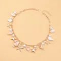 Detail of bohemian necklace with sea shells, faux pearls and gold starfish charms - Chain Starfish Conch Necklace