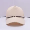 Beige baseball cap with stylish black decorative chain and metal ring accents - Black