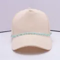 Beige cotton baseball cap with a light blue decorative chain and metal ring accents - Blue