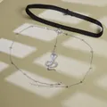 Close-up of black elastic leg chain with a silver cobra pendant and metallic beads - Silver Snake Pendant Leg Chain