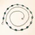 Detailed shot of a silver waist chain with green marquise stones and sparkling rhinestones - Green Gemstone