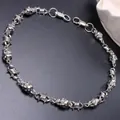 Macro detail of gothic skull and barbwire punk metal chain with lobster clasps - Silver Skull Spike Style