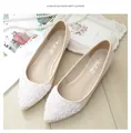 Close-up of elegant pointed-toe flat shoes with white sequin flower details - EU 38 / Apricot