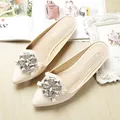Elegant beige pointed-toe flat mules with rhinestone buckle on a stylish wooden floor - EU 38 / Apricot