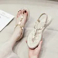 Women's flat T-strap sandals with transparent bands, rhinestones, and quilted insoles - EU 34 / Apricot