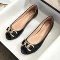 Women's black flat open-toe shoes with elegant gold metal buckle and leather-like finish - EU 34 / Black