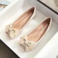 Women's beige open-toe flat shoes featuring a large bow and soft leather material - EU 34 / Apricot