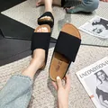 Women's minimalist flat black slide sandal with matte wide strap and cork textured sole - EU 35 / Black