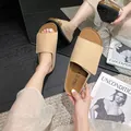 Minimalist beige open-toe flat slide sandals with matte finish and ergonomic cork sole - EU 35 / Apricot