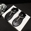 Women's black flat sandals featuring rhinestone straps and adjustable ankle buckle closure - Black Rhinestone