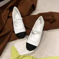 Classic black and white round-toe Mary Jane flats with ruffled elastic strap design - EU 38 / Milk White