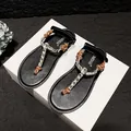 Elegant black flat flip-flops with knot straps and crystal chain embellishments - 34 / Brown Rhinestone