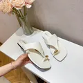 Elegant white square toe thong sandals for women featuring a stylish gold teardrop buckle - EU 35 / White