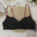 Seamless black sports bra with striped straps and elastic ribbed fabric texture - S / Black