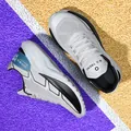 Light grey breathable mesh running shoes with thick white soles on a colorful track - 39 / Gray