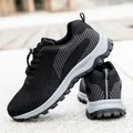 Men and women's black walking shoes with breathable mesh and anti-slip rubber soles - Black